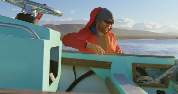 Man checking motorboat near river side 4k