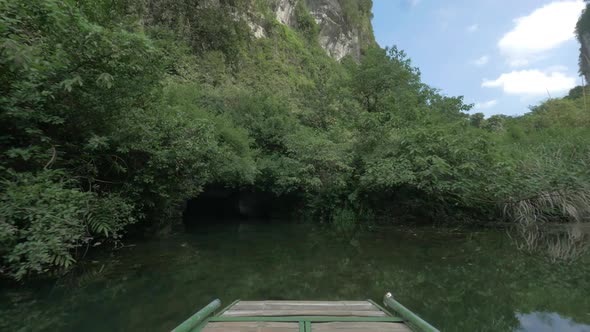 Boat sailing into karst cave Trang An, Vietnam