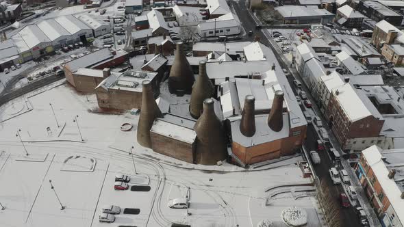 Aerial view of the famous bottle kilns at Gladstone Pottery Museum, covered in snow on a cold winter