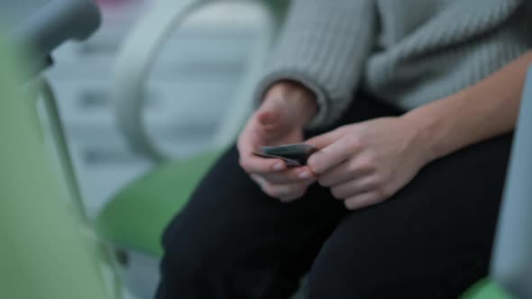 Closeup Condoms in Hands of Unrecognizable Teenage Girl Hiding Protective Contraceptive in Pocket