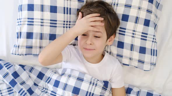 Little Boy Suffering From Headache at Home