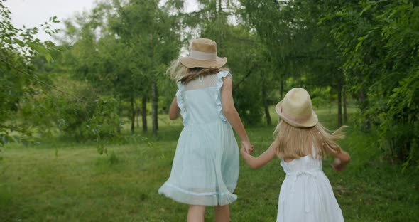 Little Girls Run Through Forest Park Happy Kid Paying in Garden Children