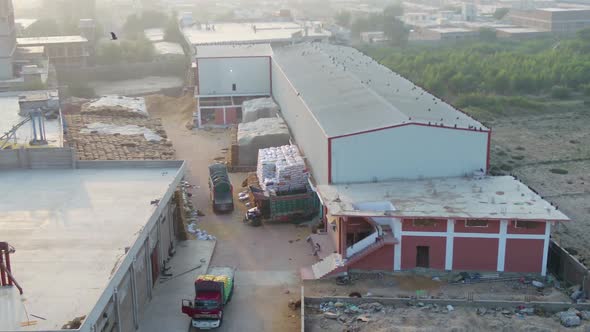 Aerial view of a semi trucks with cargo trailers standing on warehouses ramps for loading  unloading