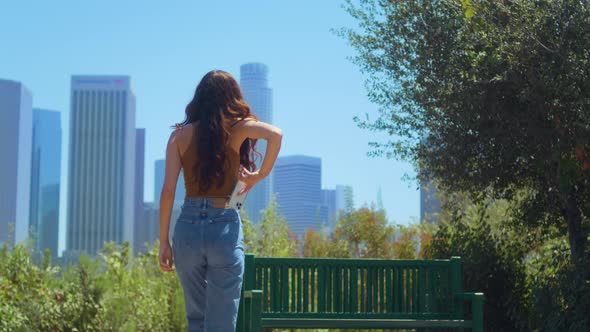 Unrecognizable Girl Walking Park to Make Photo Cityscape