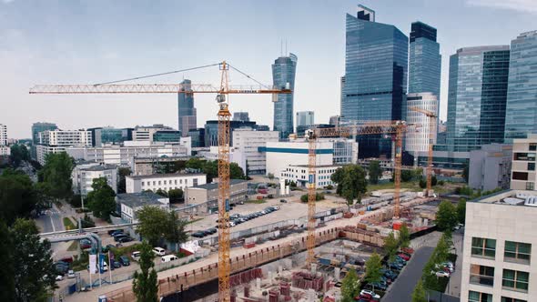 Yellow Cranes at Construction Site in the Centre of Warsaw Poland with Apartment Buildings and