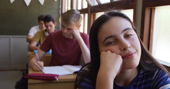 Portrait of teenage girl in a school classroom alt