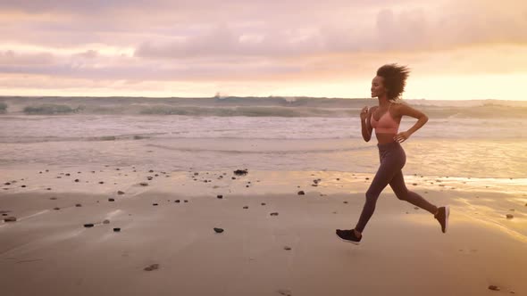 Somali woman jogging on the beach in Malibu