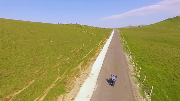 Motorcyclist driving his motorbike on the mountain road in the country side.