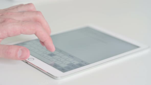 Close Up of Finger Typing on Digital Tablet