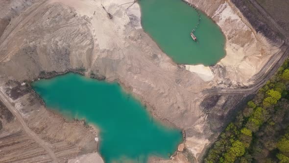 Aerial view of a sand quarry full with green water