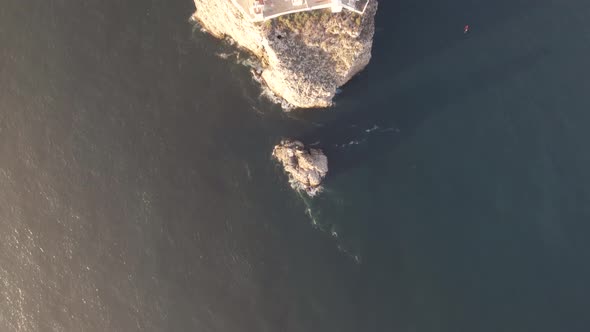 Top down aerial of Cape Sao Vicente Lighthouse. Headland cliffs and ocean view.