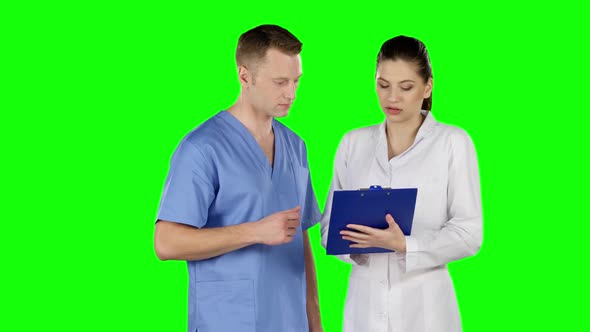 Two Doctors Explaining About Patient. Green Screen