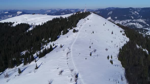 Flying Over Radio Communications Tower, Mountain Snow Covered Winter Landscape.