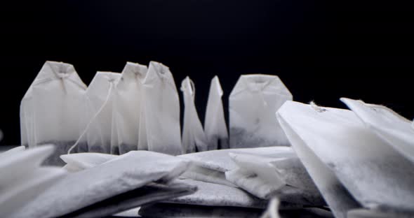 Super Closeup Set of Tea Bags on a White Table on a Black Background