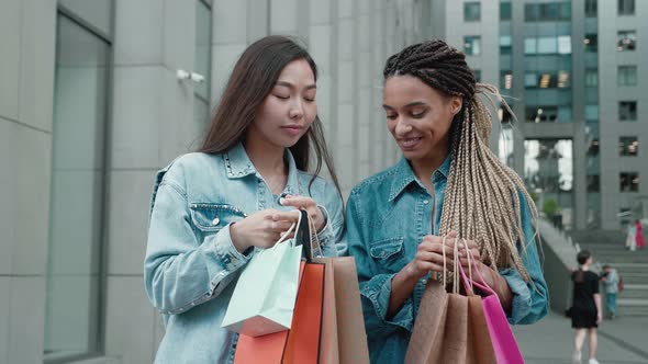 Friends Portrait with Two Happy Young Women Smiling with Shopping Bags After Buying Clothes in
