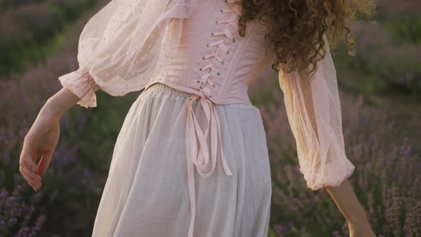 Woman in a Pink Dress Running Joyfully Through a Lavender Field