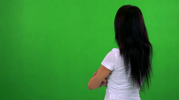 Young Pretty Woman Looks Around - Shot on Back (Woman Looks To Screen) - Green Screen - Studio