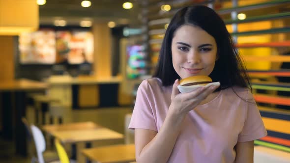 Happy Woman Enjoying Smell of Tasty Burger and Smiling on Camera, Sandwich Club