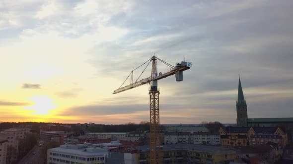 Aerial view of construction site of new residential building wint tower crane.