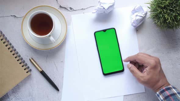 Top View of Man Hand Using Smart Phone on Office Desk