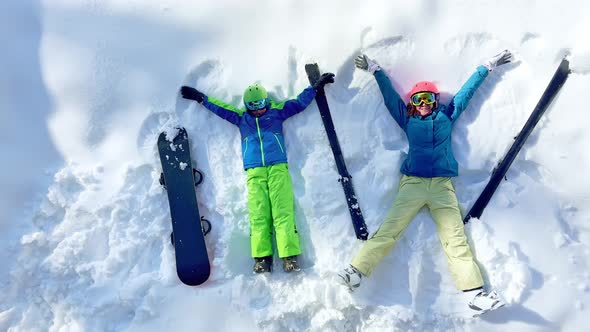 Ski Woman and Young Boy with Snowboard View From Above