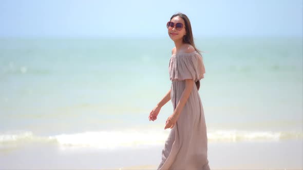 Asian woman enjoy around beautiful beach sea ocean