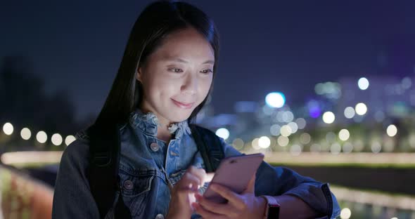 Woman use of cellphone in the evening