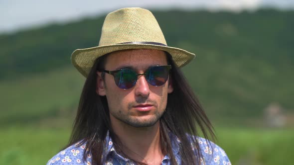 Close up of a man with hat and sunglasses