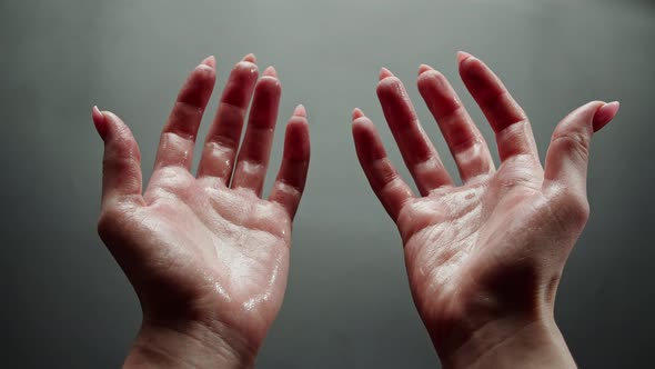 Female Hands on Grey Background Woman Showing Wet Palms and Fingers Closeup Human Skin Texture