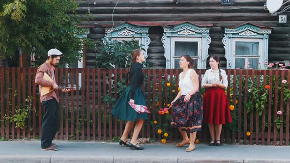 Young Women in Long Skirts Dancing Folk Dances on the Street in the Village By the Music