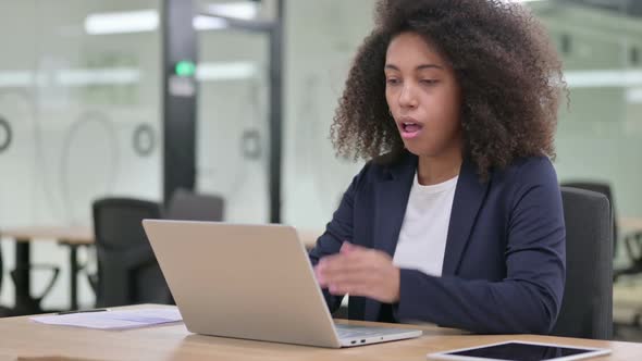 Sick Young African Businesswoman with Laptop Coughing