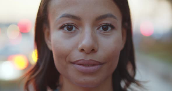 Bokeh Closeup Portrait of Smiling African Woman on Street