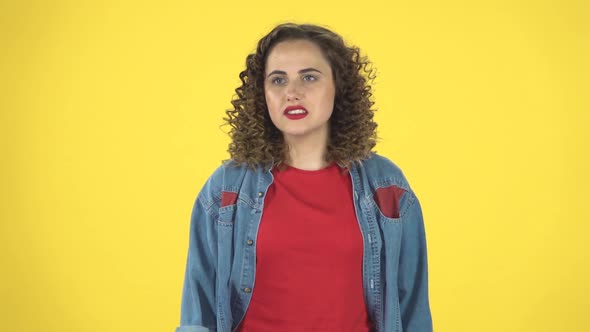 Curly Female Feels Very Bad, Her Stomach Hurts on Yellow Background at Studio, Slow Motion