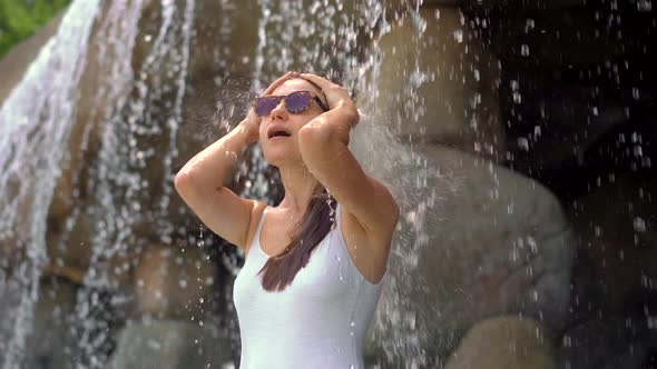 A Young Woman in a Tropical Resort with Hot Springs, Waterfalls and Swimming Pools with Hot Mineral