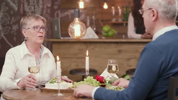 Beautiful Senior Couple on a Date Tasting White Wine