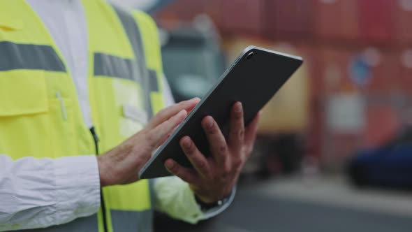 Close Up of Man Using Tablet at Warehouse Harbor