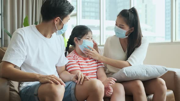 asian healthy wellness family wearing surgical facial mask together and stay home