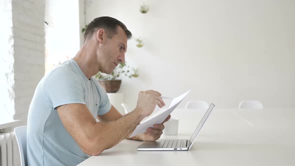 Man Reading Documents Paperwork
