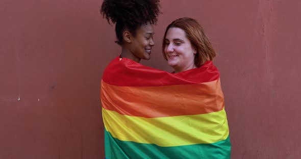 Multiracial lesbian couple smiling on camera - LGBT pride concept
