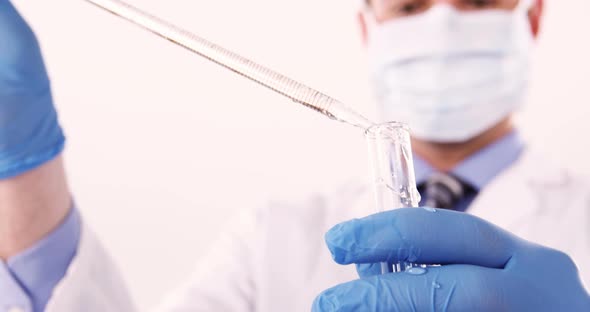 Lab technician checking sample in tube