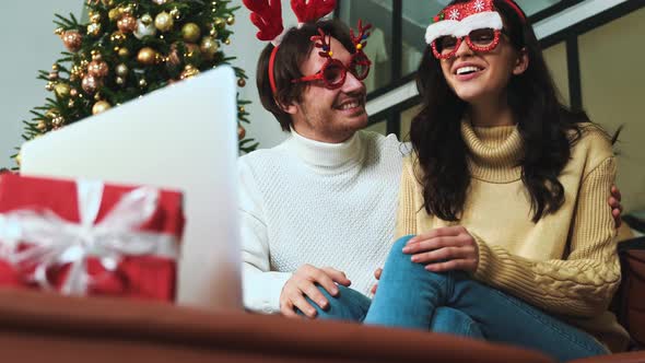 Happy couple celebrating christmas at home.