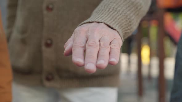 Close-up Handstack of Senior Man and Children Outdoors. Unrecognizable Caucasian Grandfather