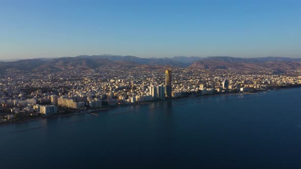 City with Multistory Buildings Against Mountains at Dawn