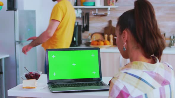 Business Woman Working on Laptop with Green Screen