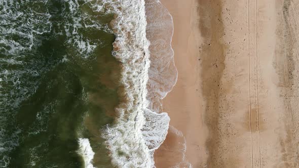 Drone Flight Over the Azure Sea with Waves and Sandy Coast