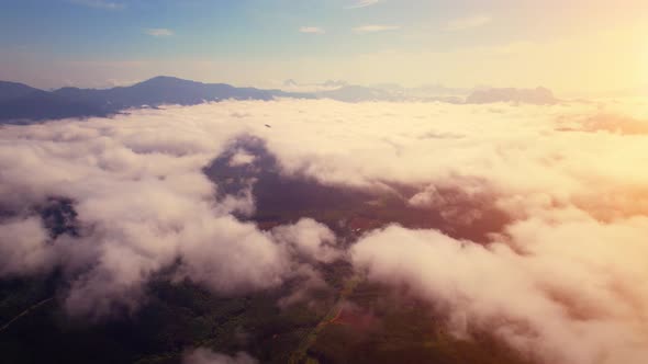 Drone flying above the clouds during sunrise