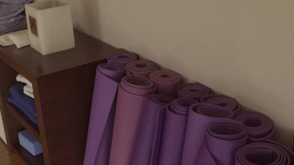 Yoga mats rolled up in yoga studio