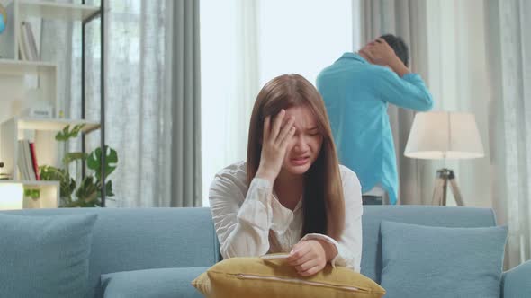 Sad Young Woman Holding Pregnancy Test. Man Is Walking And Expressing Disappointment On Background