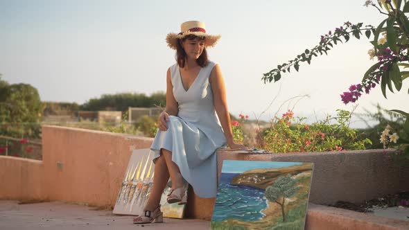 Wide Shot of Relaxed Talented Caucasian Woman Sitting Outdoors Admiring Golden Sunset with Beautiful