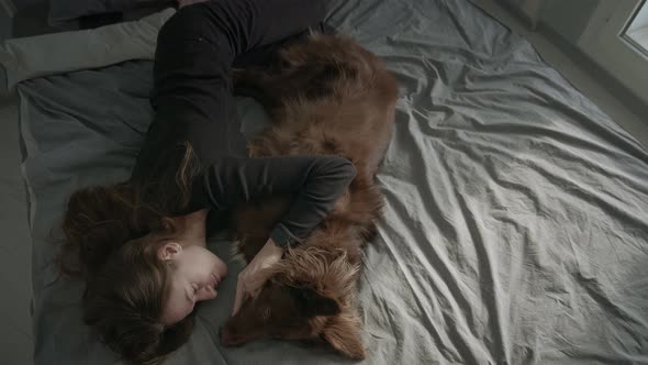Woman On Bed With Her Dog